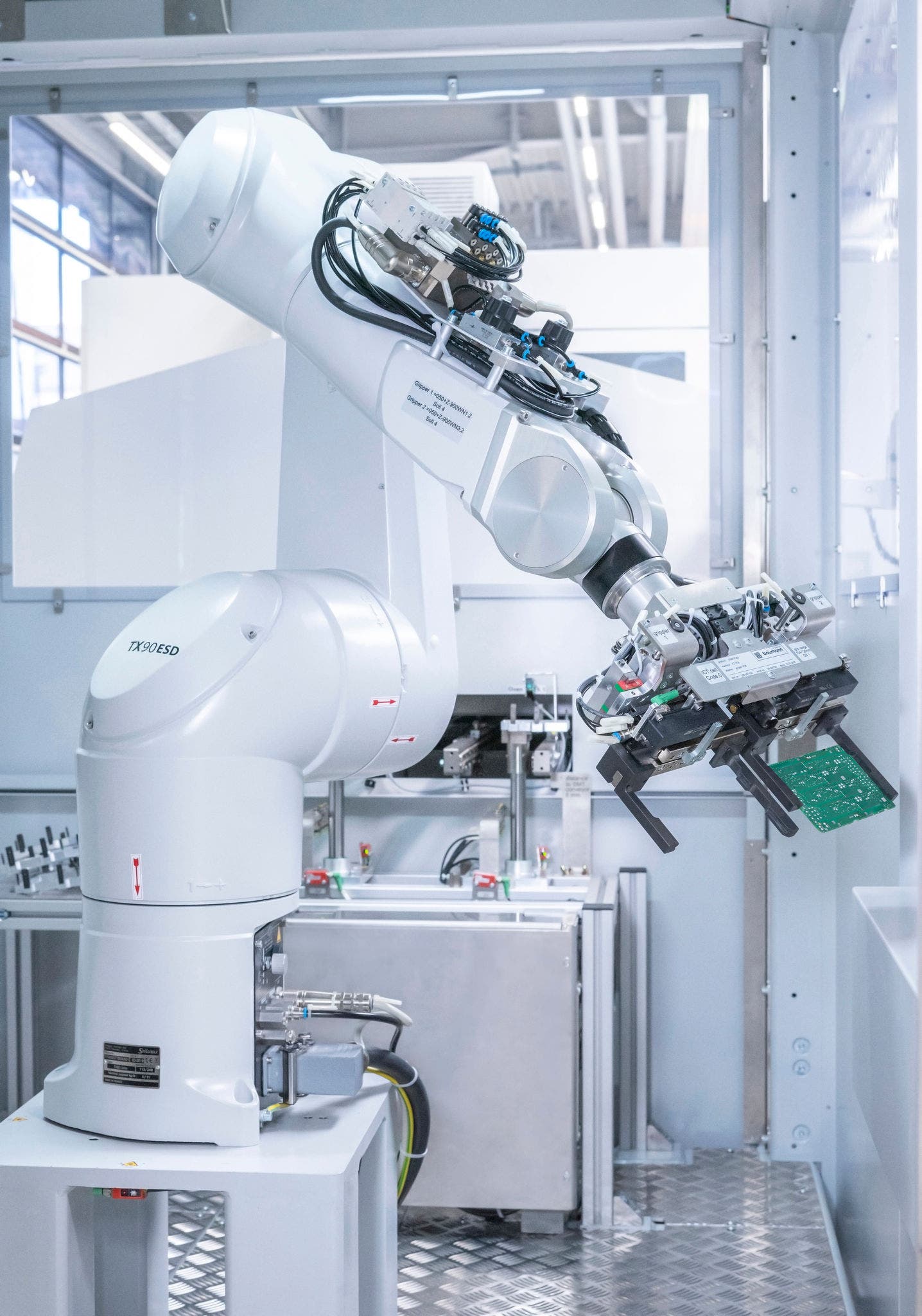 Stäubli robot being used for assisted testing of printed circuit boards in automotive electronics.