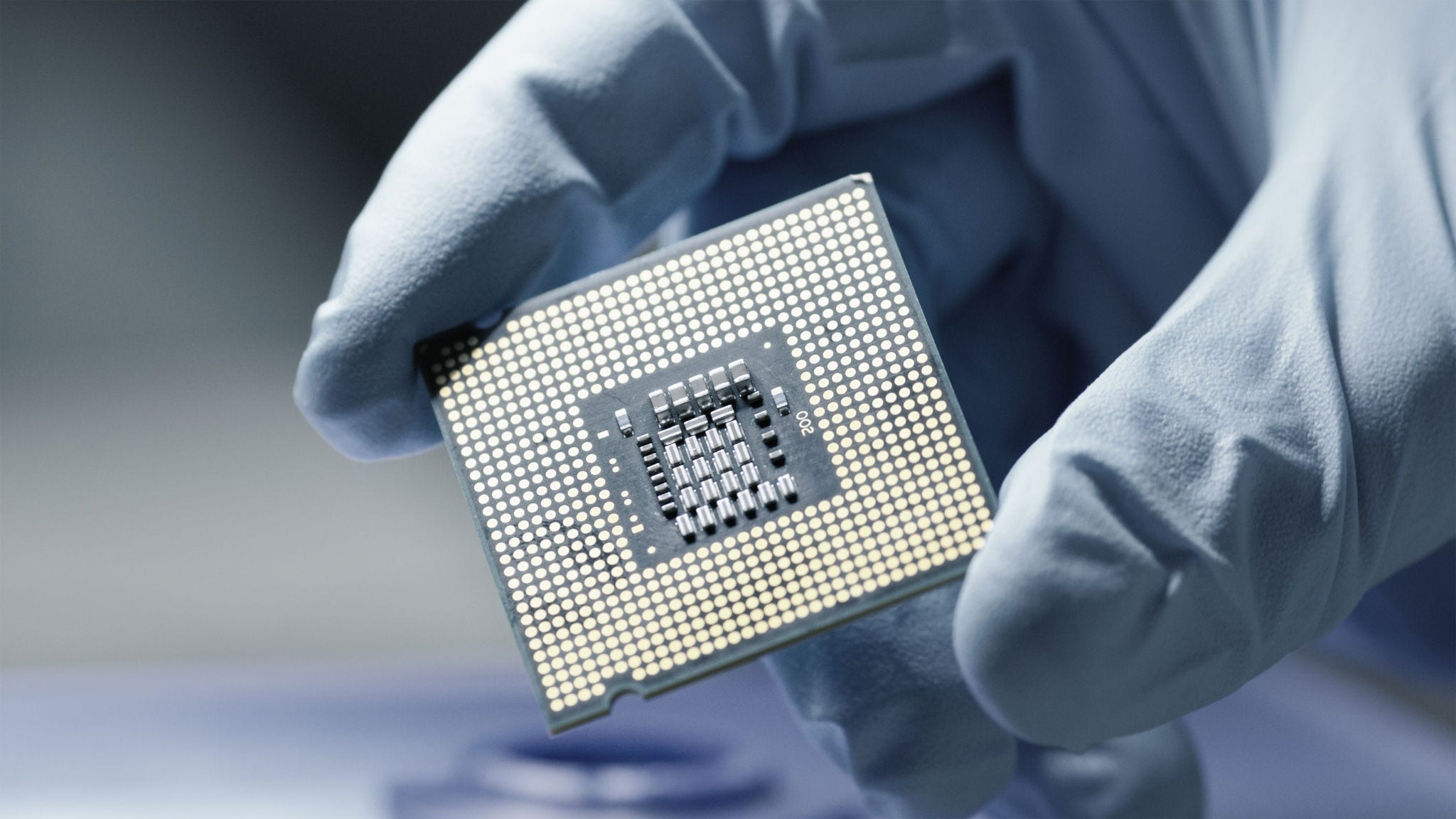 semiconductor-shutterstock Close-up Presentation of a New Generation Microchip. Gloved Hand Holding Piece of Technological Wonder.